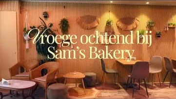 De lunchroom van Sam's Bakery met rieten stoelen en planten