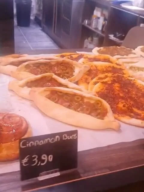 Hartig gevuld plat brood met olijven en kruiden op de toonbank